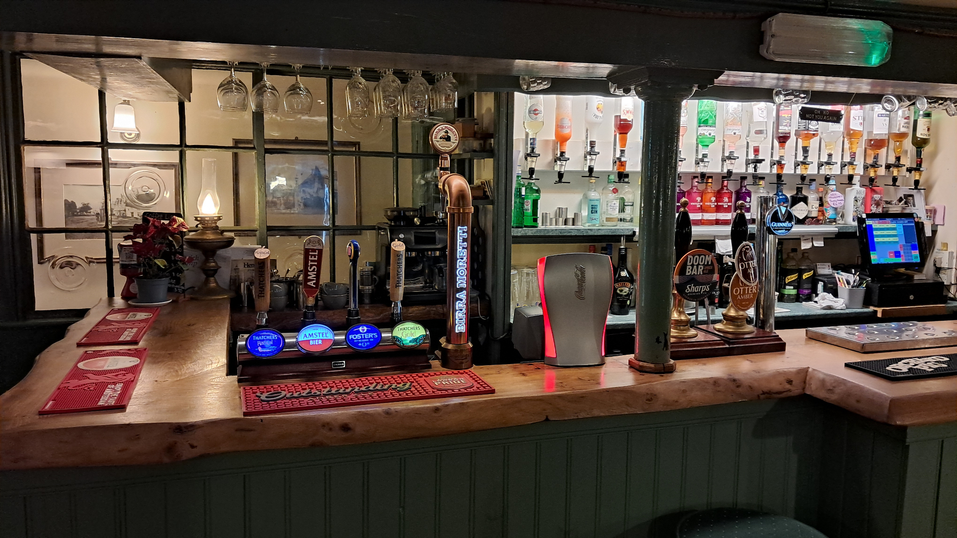 Traditional pub bar with beer taps including local ales and craft beers