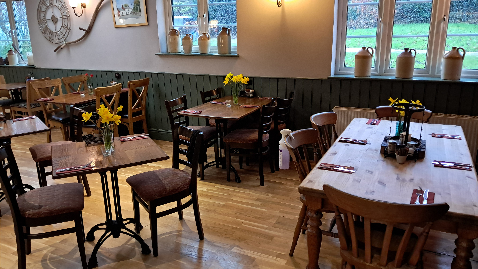 Cosy pub dining room with traditional wooden tables and fresh flowers
